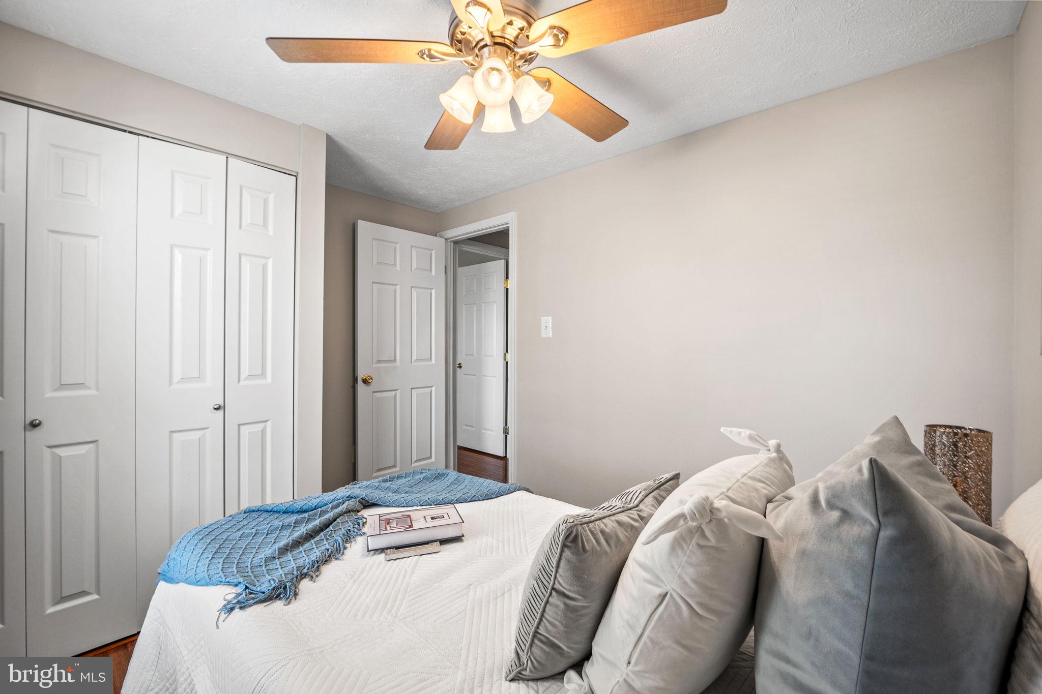 1747 Sundance Drive Reston, VA 20194 - Photo 20 of 36 a bedroom with a bed and a chandelier