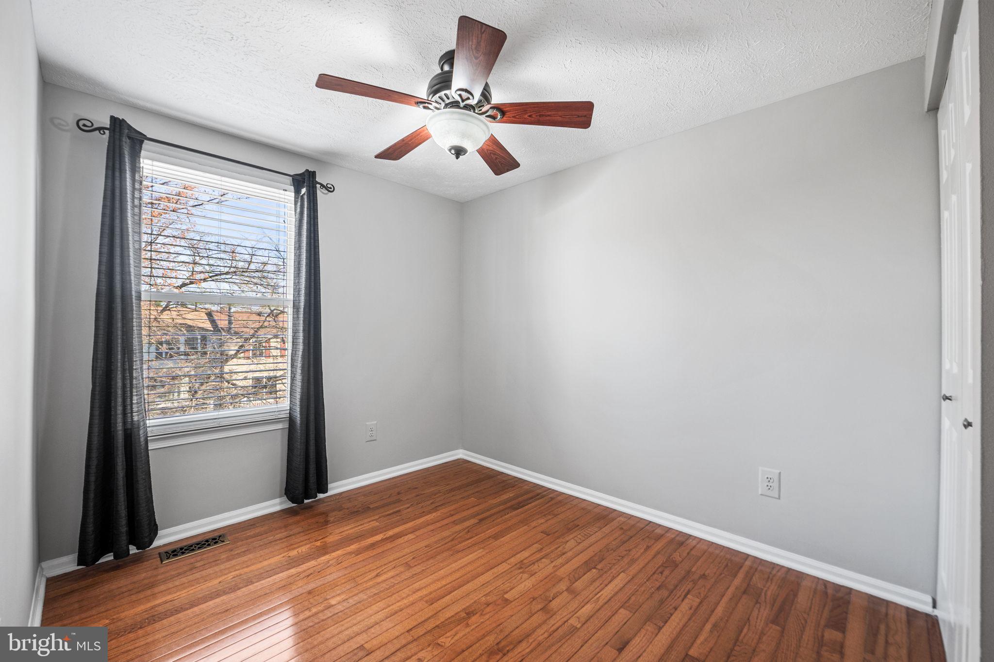 1747 Sundance Drive Reston, VA 20194 - Photo 21 of 36 an empty room with wooden floor fan and windows