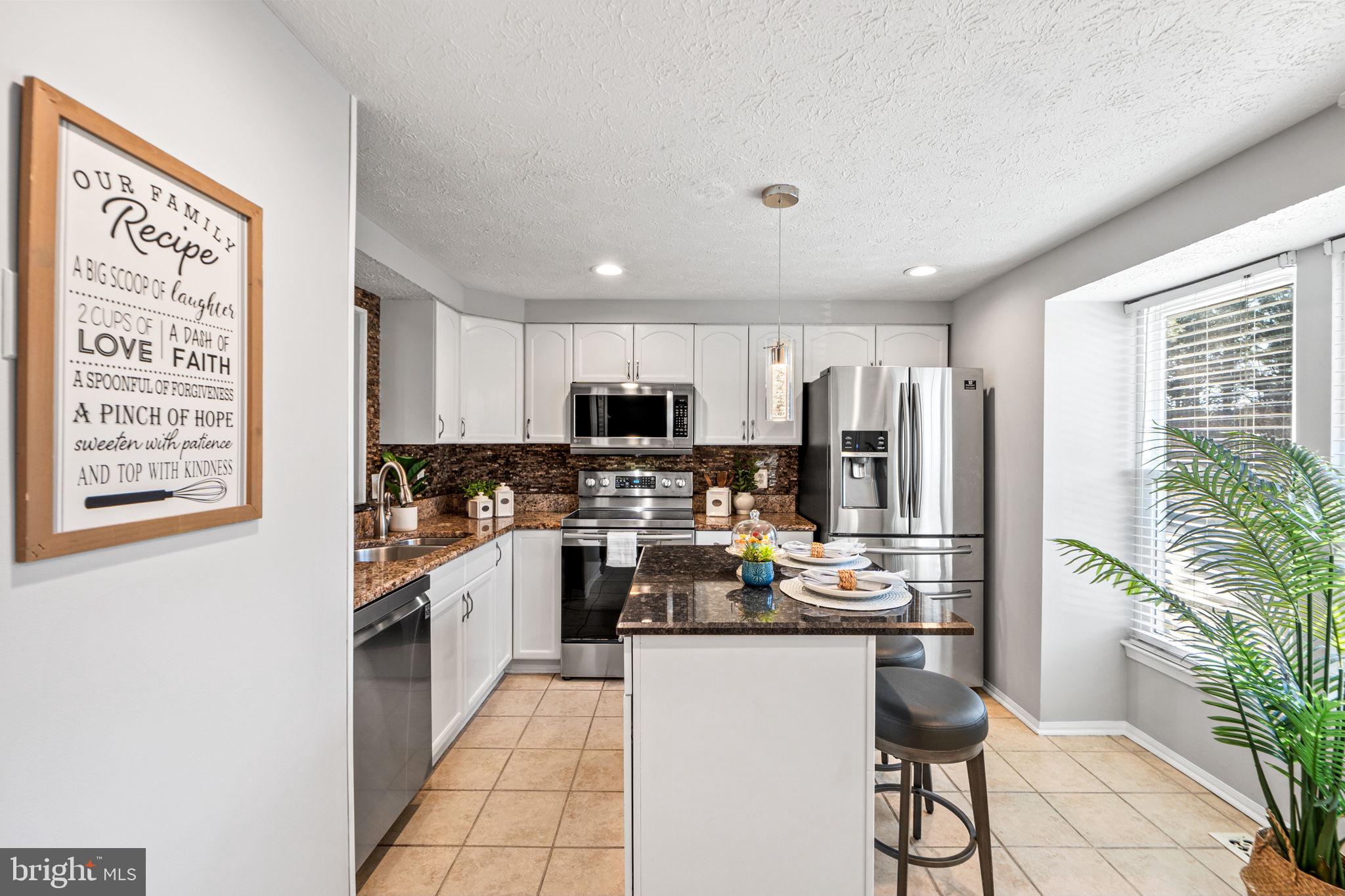 1747 Sundance Drive Reston, VA 20194 - Photo 4 of 36 a kitchen with refrigerator and cabinets
