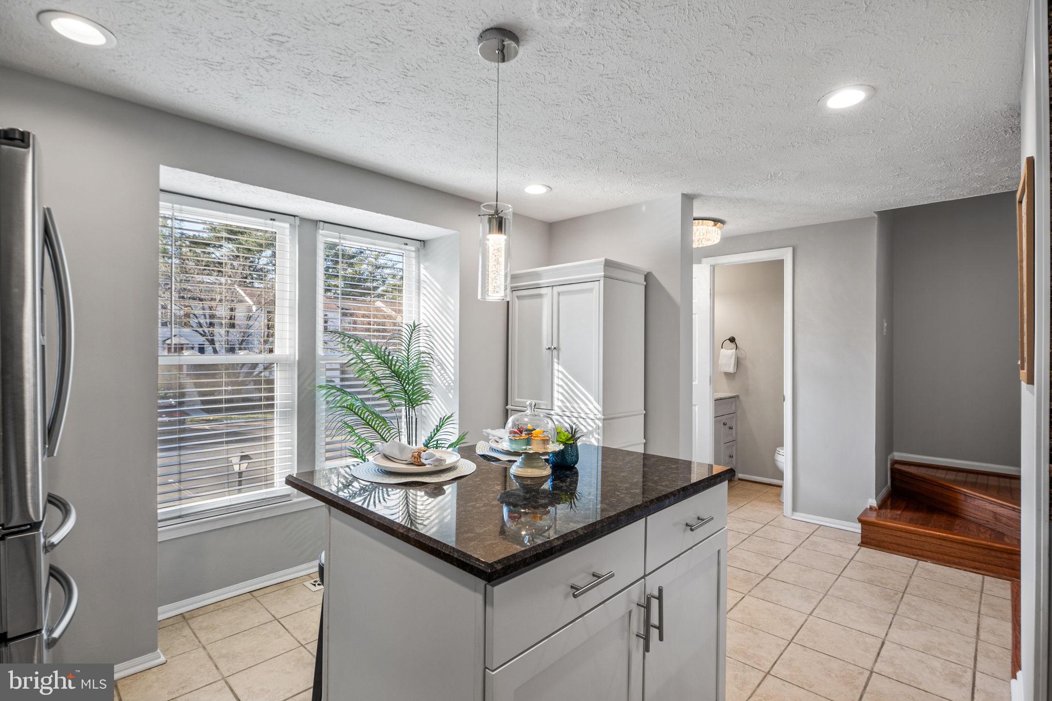 1747 Sundance Drive Reston, VA 20194 - Photo 6 of 36 a kitchen with granite countertop a sink and a counter top space