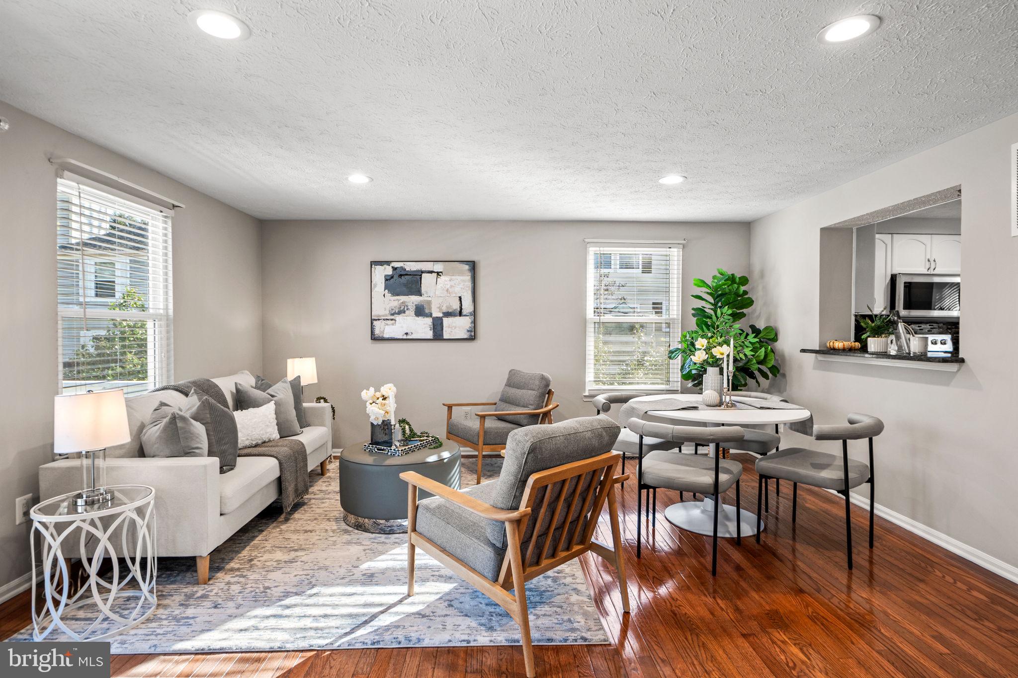 1747 Sundance Drive Reston, VA 20194 - Photo 8 of 36 a living room with furniture a dining table and a potted plant