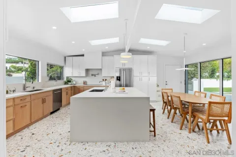 a kitchen with stainless steel appliances kitchen island granite countertop a sink and cabinets
