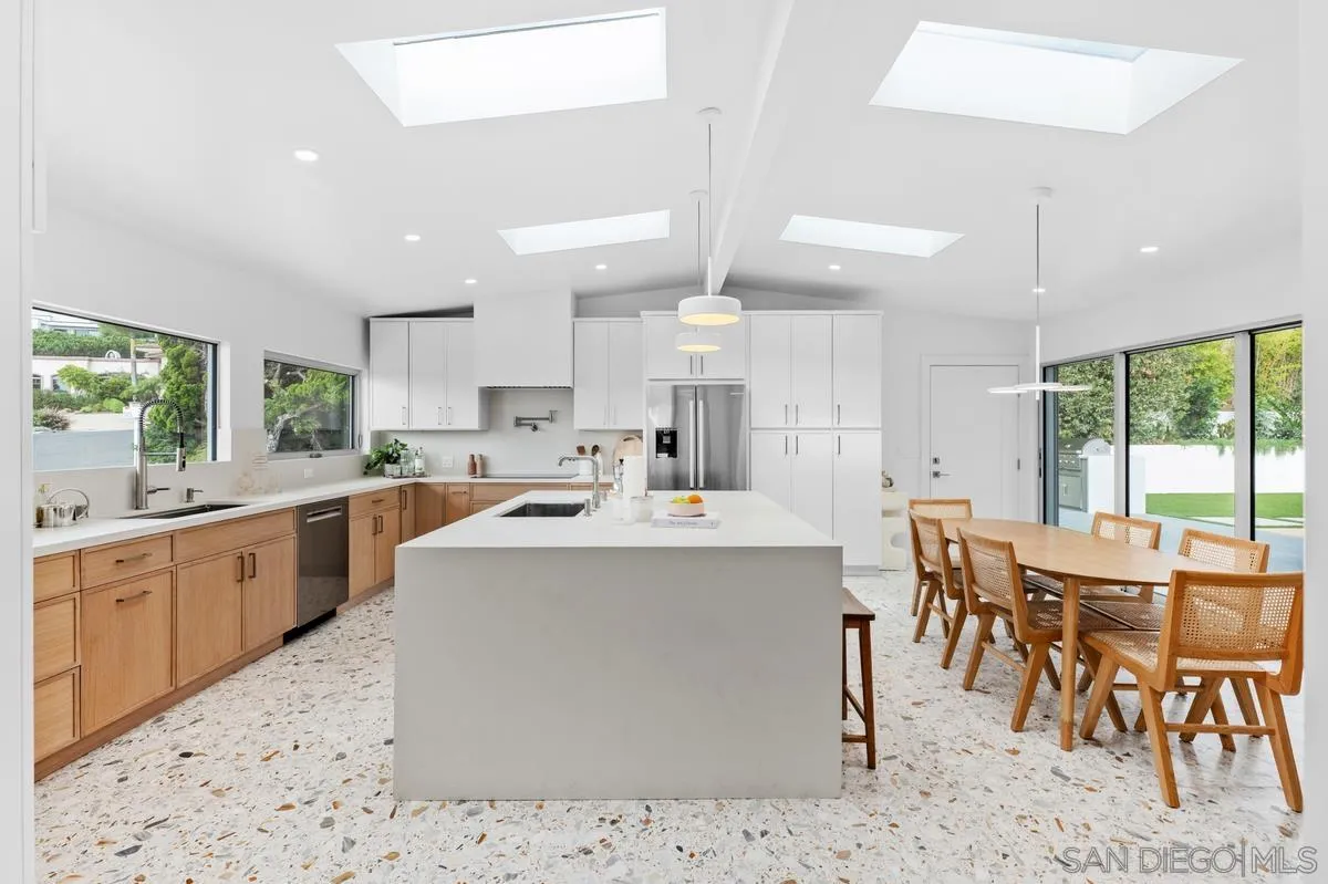5851 Box Canyon Road La Jolla, CA 92037 - Photo 12 of 39 a kitchen with stainless steel appliances kitchen island granite countertop a sink and cabinets