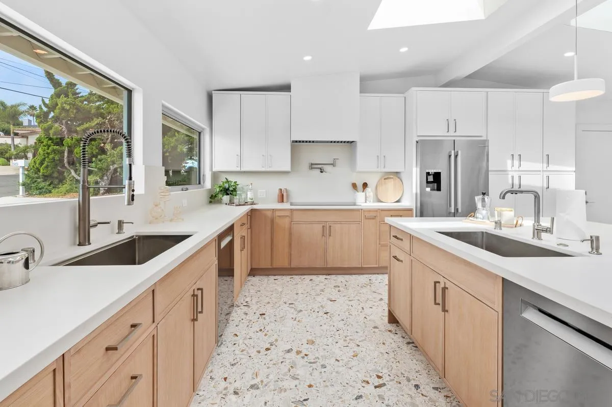 5851 Box Canyon Road La Jolla, CA 92037 - Photo 14 of 39 a kitchen with kitchen island granite countertop a sink a counter top space stainless steel appliances cabinets and a large window