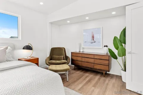 a bedroom with furniture and a potted plant