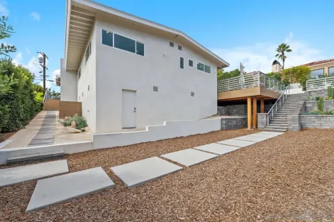 a front view of a house with a road