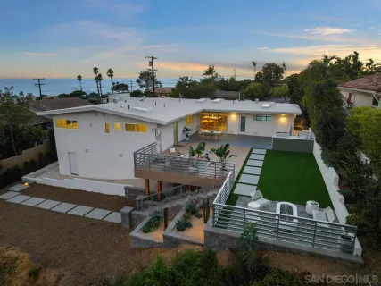 an aerial view of a house with swimming pool patio and outdoor seating