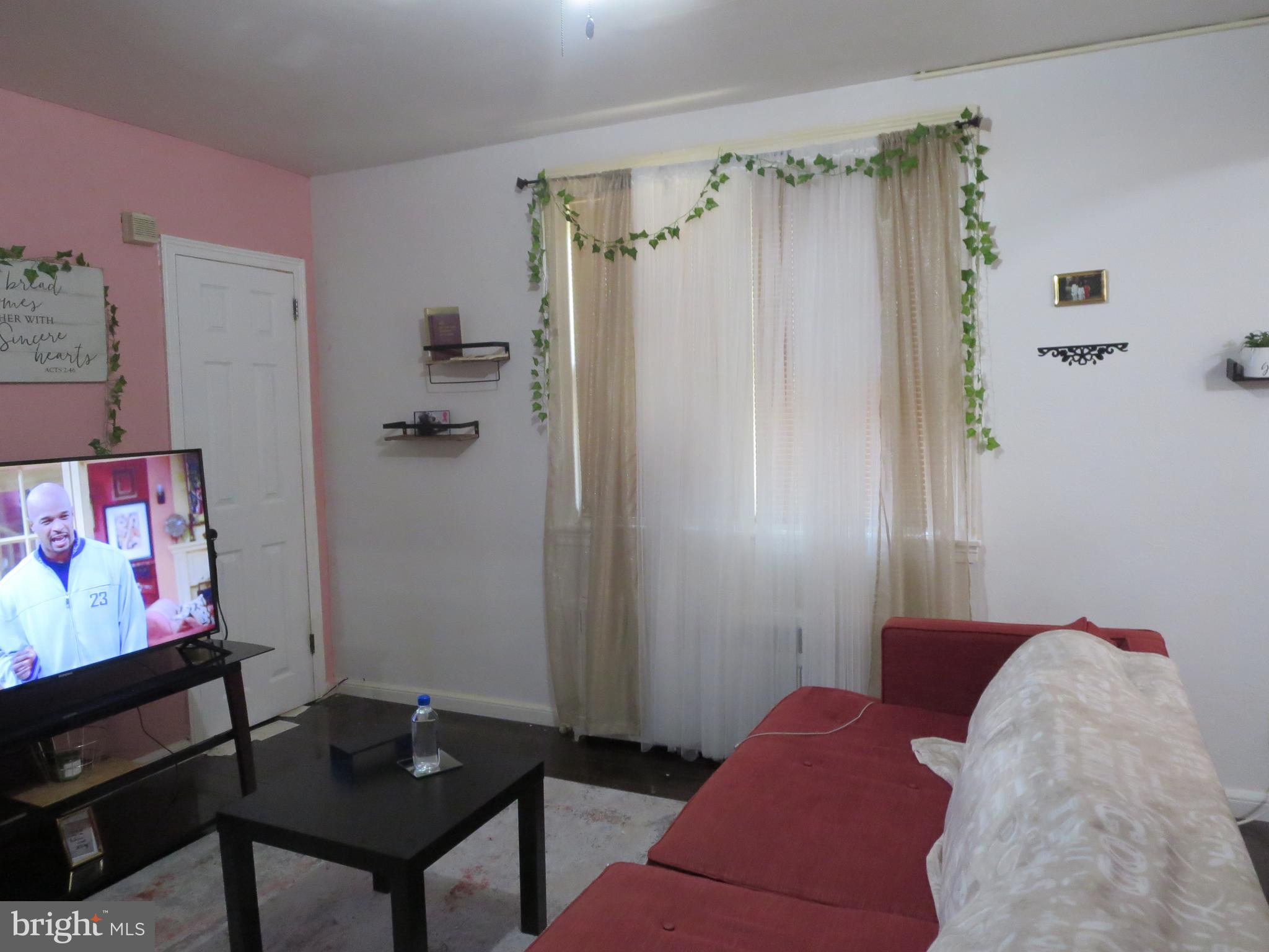 1025 Fanshawe Street Philadelphia, PA 19111 - Photo 3 of 13 a bedroom with a bed and a table in it