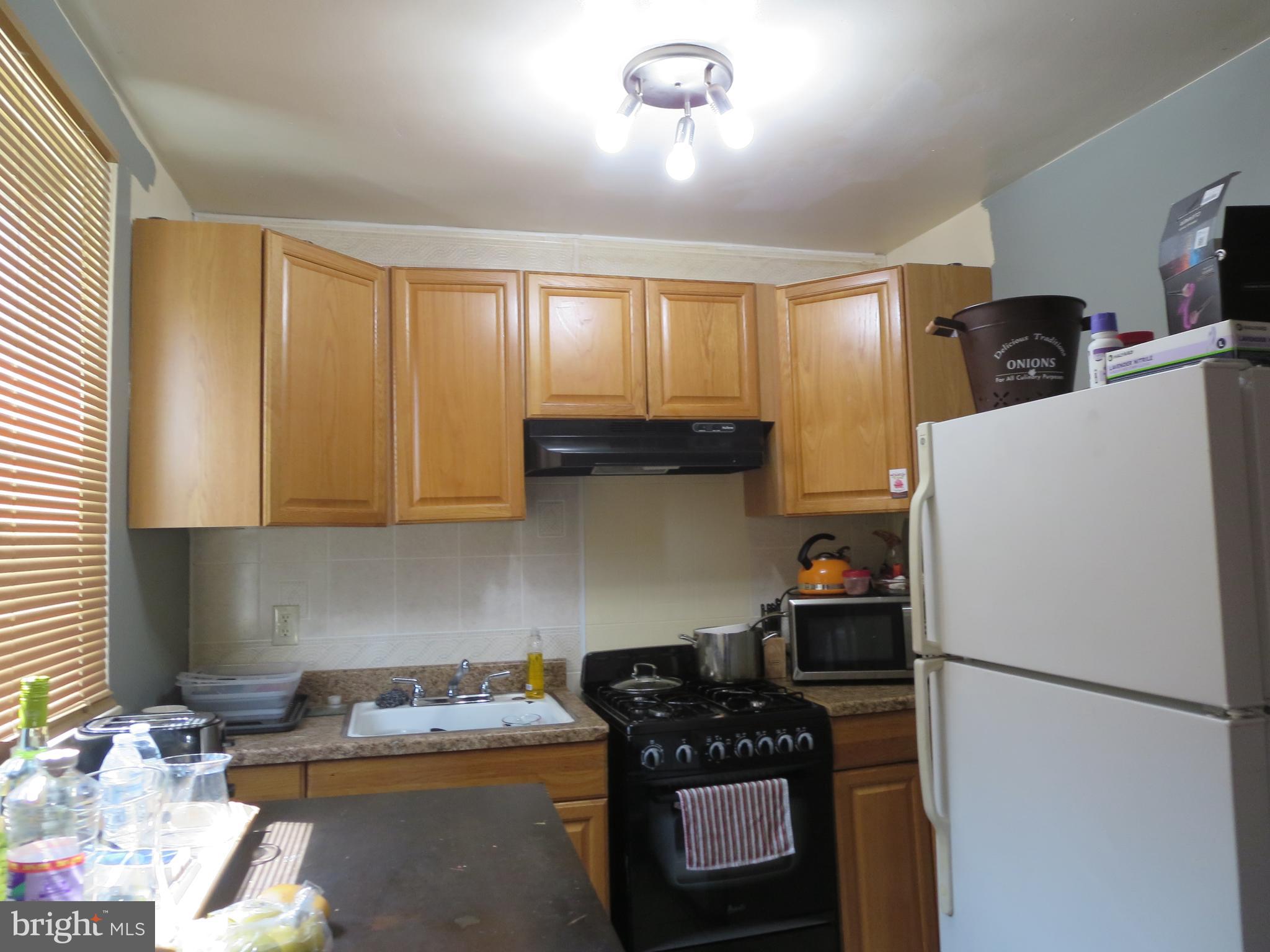 1025 Fanshawe Street Philadelphia, PA 19111 - Photo 5 of 13 a kitchen with a refrigerator and a stove top oven