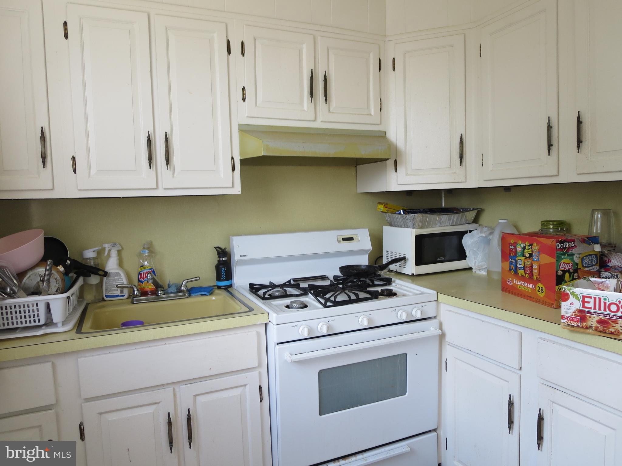 1025 Fanshawe Street Philadelphia, PA 19111 - Photo 10 of 13 a kitchen with white cabinets and appliances