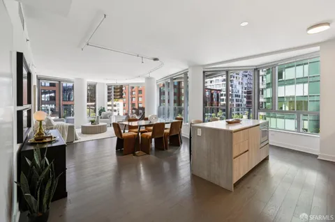 a living room with furniture and large windows