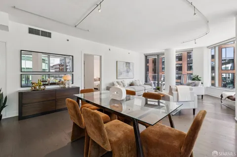 a living room with furniture and large windows