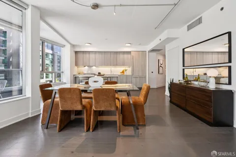 a large kitchen with kitchen island a sink a stove and wooden cabinets