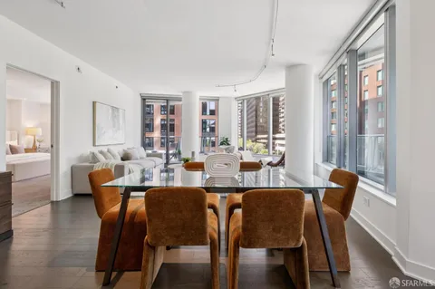 a kitchen with a sink and chairs