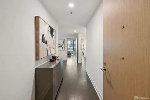 a hallway with a large mirror and furniture