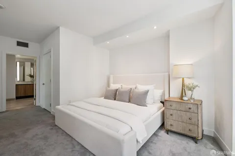 a bedroom with a bed and a lamp
