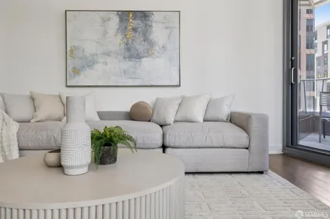a living room with furniture and a potted plant