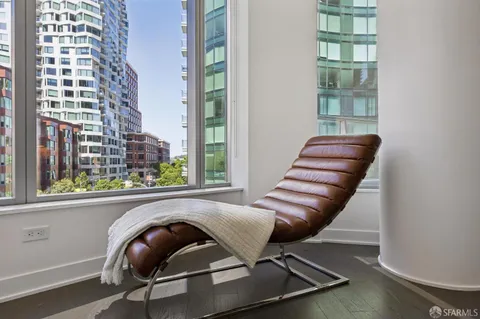 a living room with furniture and kitchen view