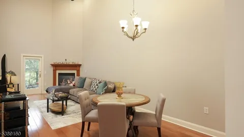a view of a dining room with furniture a chandelier and wooden floor