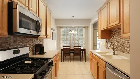 a kitchen with stainless steel appliances a stove a sink and a microwave
