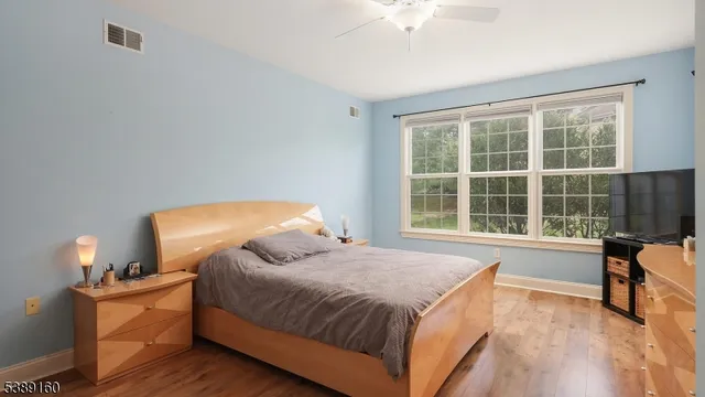 a spacious bedroom with a bed and a table with chair