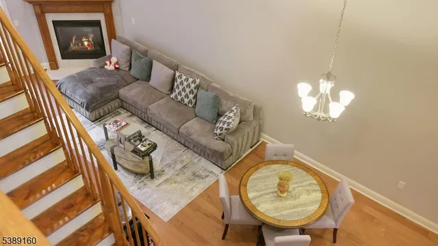 a living room with furniture and a chandelier