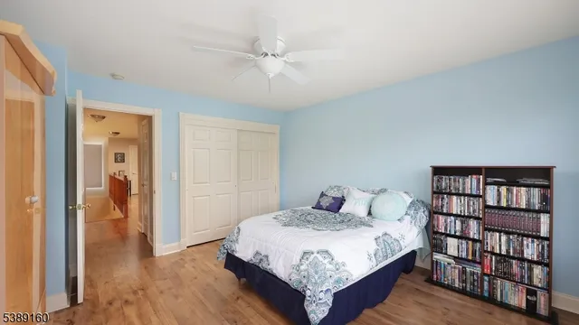 a bedroom with a bed and a book shelf