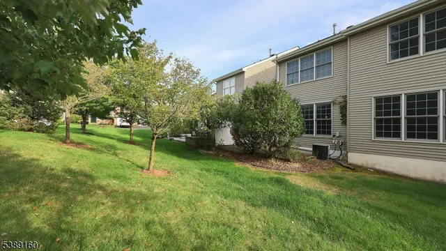 a view of a backyard with a slide trees and a wooden fence