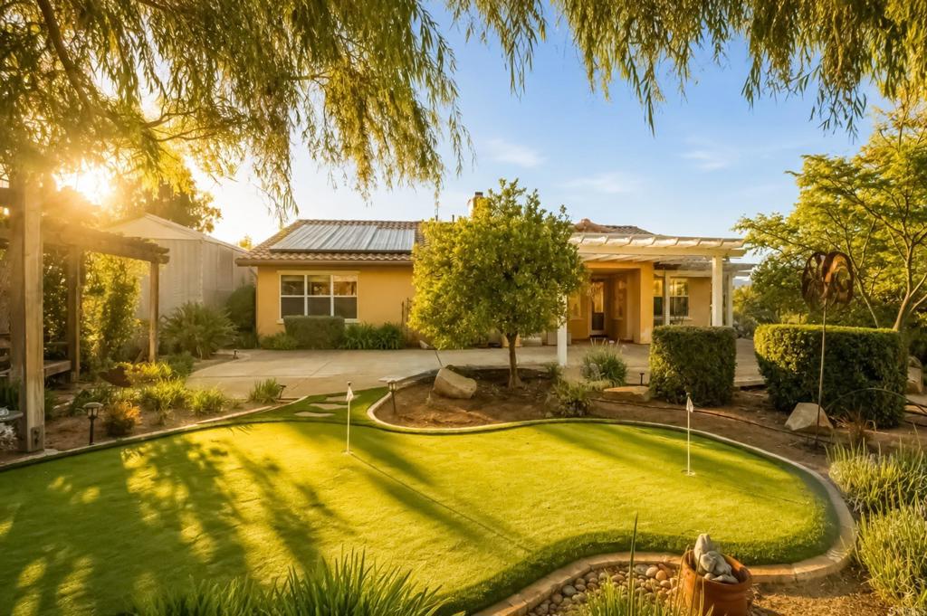 2527 Southern Oak Road Ramona, CA 92065 - Photo 4 of 56 a view of a swimming pool with plants and palm trees
