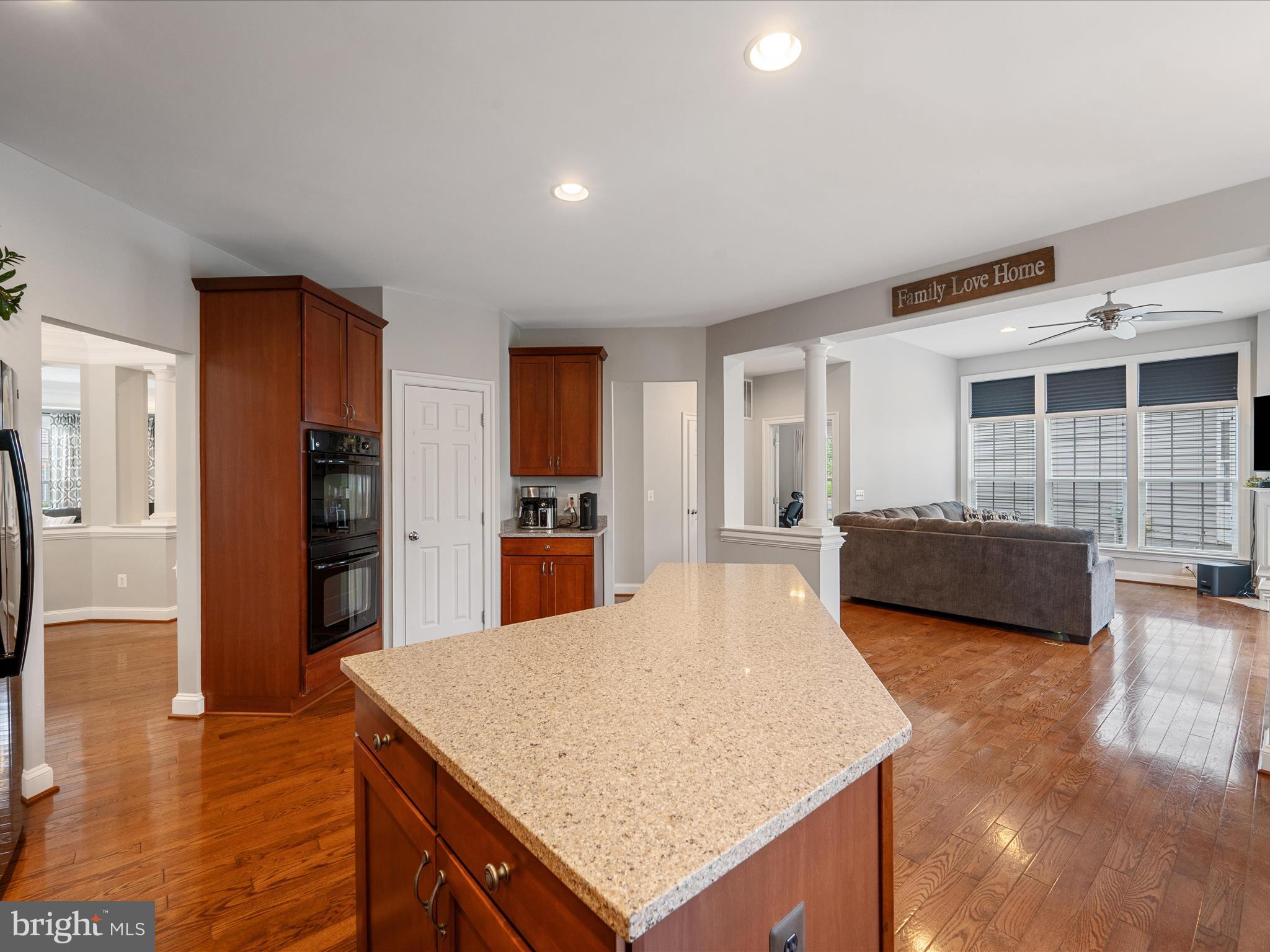 103 Prairie Place Stephenson, VA 22656 - Photo 12 of 90 a living room with stainless steel appliances kitchen island granite countertop a refrigerator a sink dishwasher and white cabinets with wooden floor