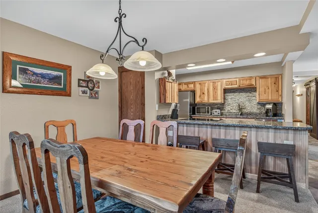 a dining room with furniture a chandelier and window