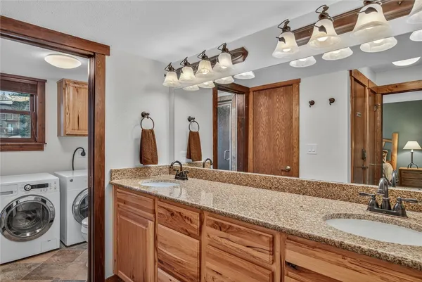 a bathroom with a sink double vanity and a mirror