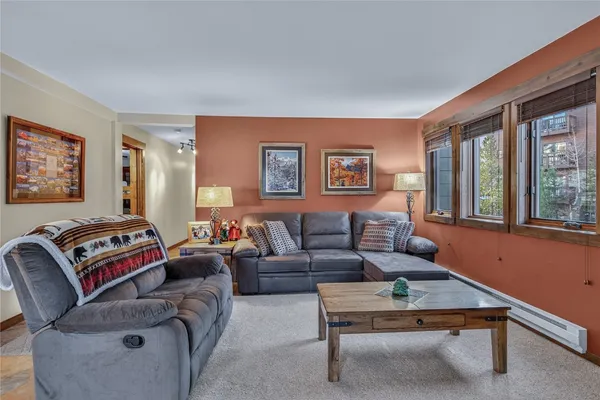 a living room with furniture a couch and windows
