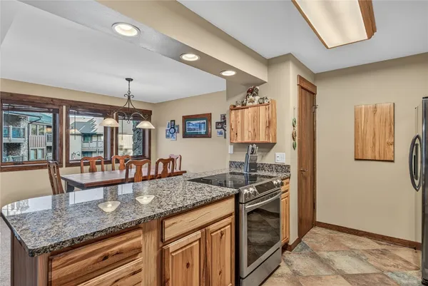 a kitchen with stainless steel appliances granite countertop a stove and a sink