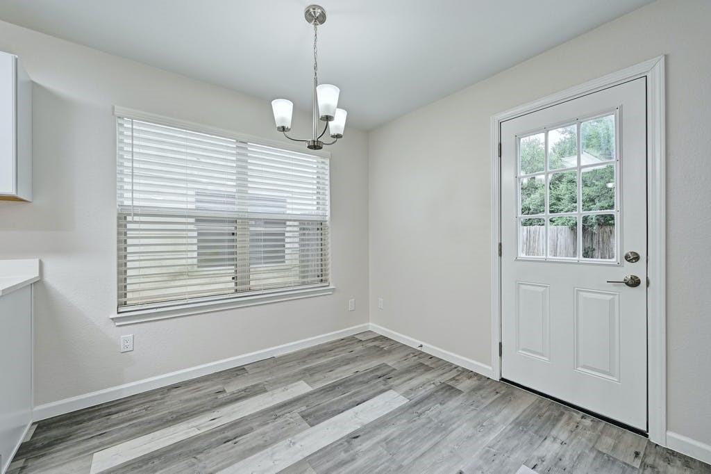 2320 Riddle Road, Unit A Austin, TX 78748 - Photo 11 of 25 an empty room with wooden floor exposed radiator and windows