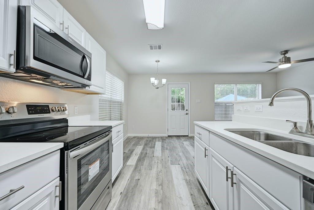 2320 Riddle Road, Unit A Austin, TX 78748 - Photo 13 of 25 a kitchen with a sink and steel appliances
