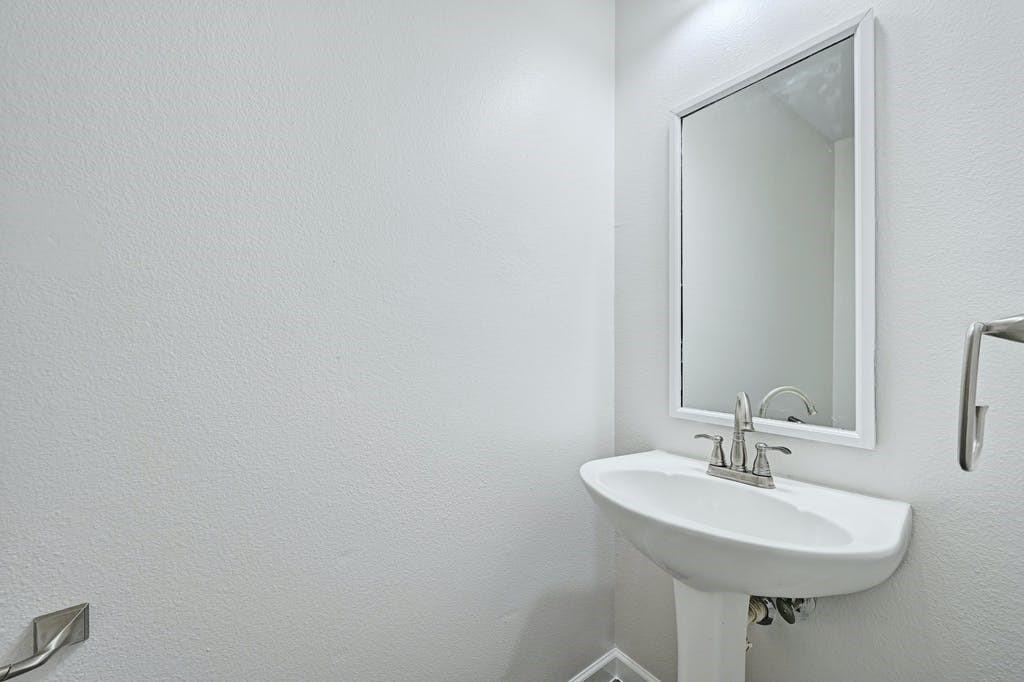 2320 Riddle Road, Unit A Austin, TX 78748 - Photo 15 of 25 a bathroom with a sink and a mirror