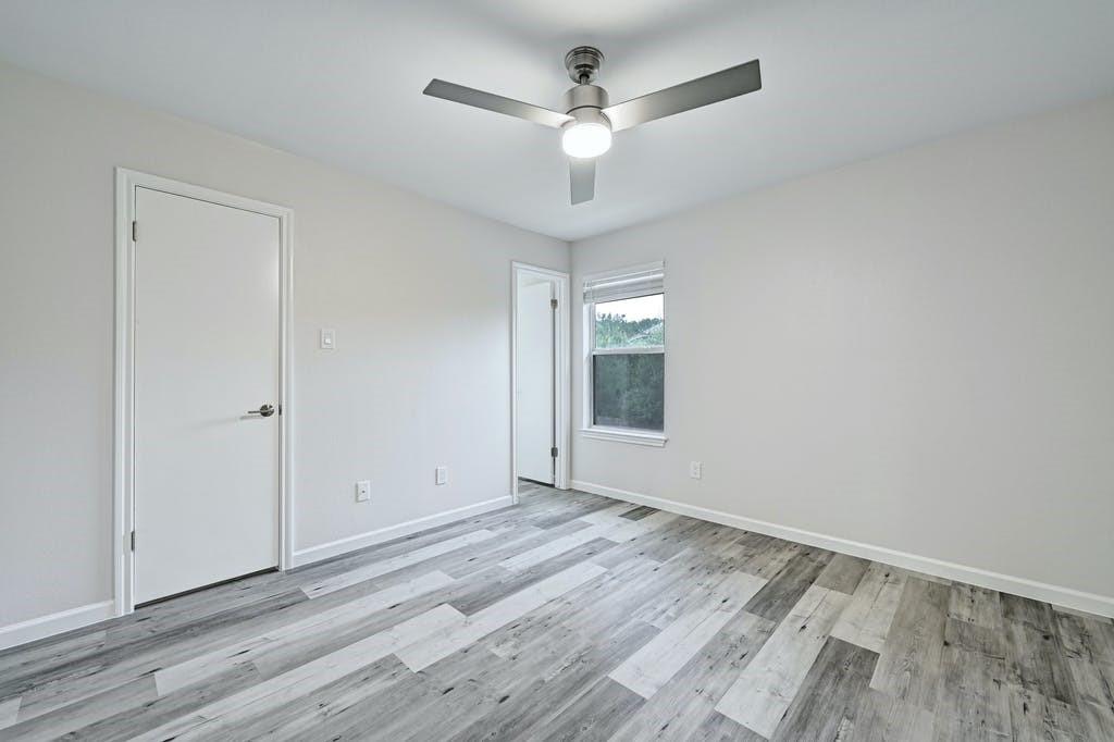 2320 Riddle Road, Unit A Austin, TX 78748 - Photo 16 of 25 wooden floor in an empty room with a window