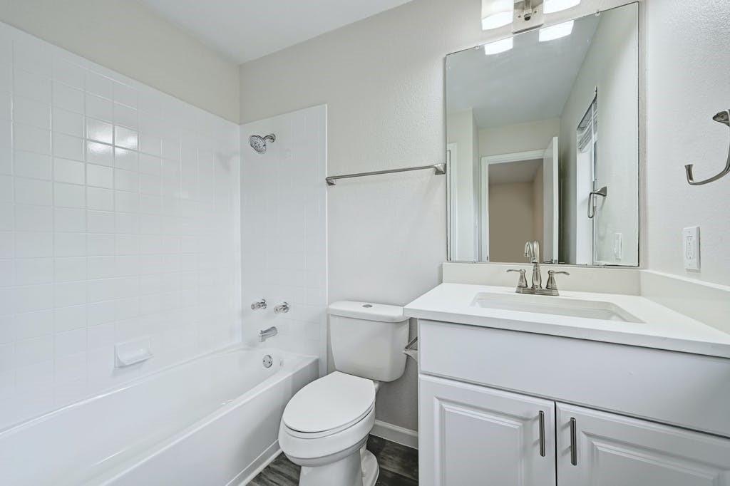 2320 Riddle Road, Unit A Austin, TX 78748 - Photo 18 of 25 a bathroom with a sink toilet vanity and shower
