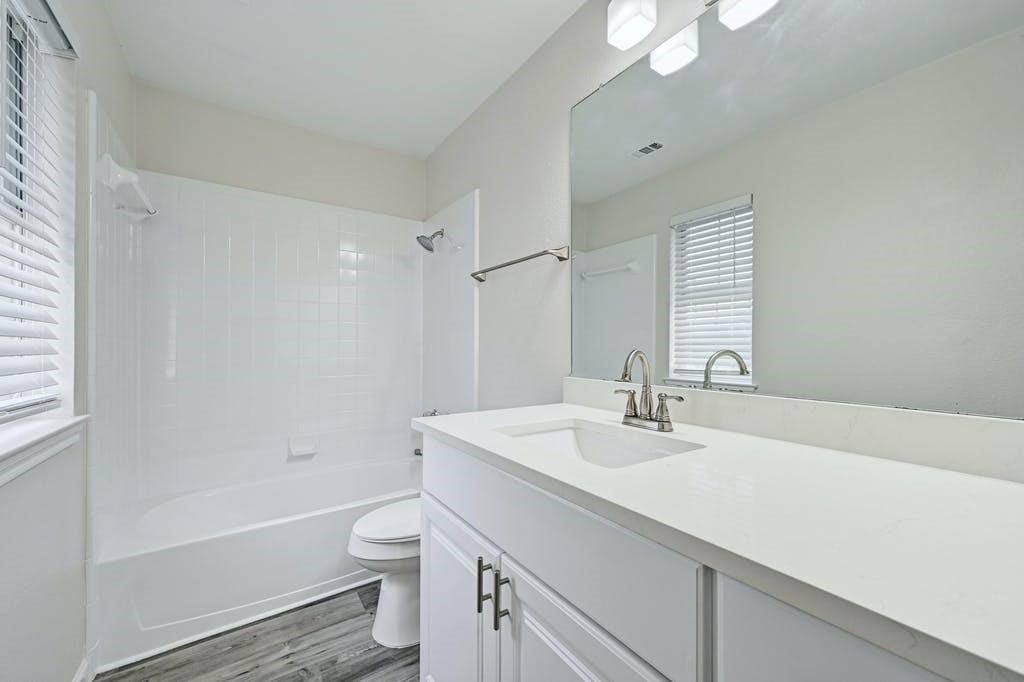 2320 Riddle Road, Unit A Austin, TX 78748 - Photo 21 of 25 a bathroom with a sink a toilet and shower