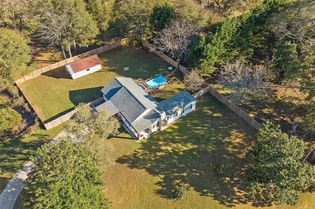 a open kitchen with stainless steel appliances granite countertop a refrigerator dining table and chairs with wooden floor