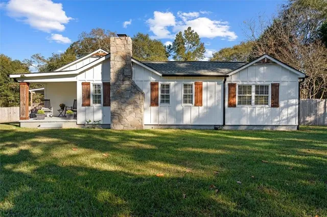 a front view of house with yard and green space