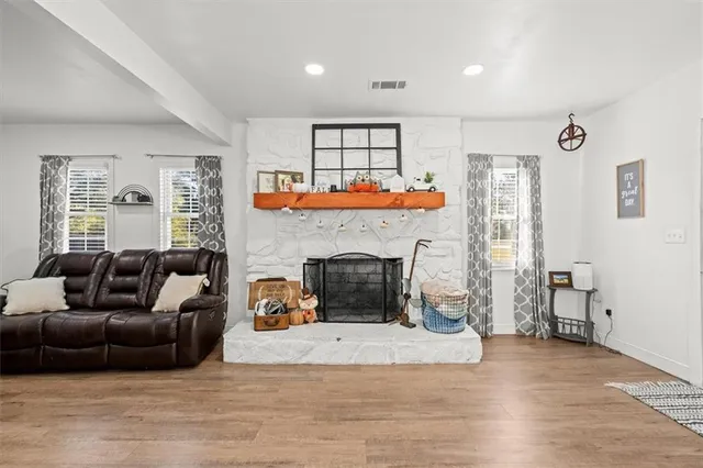 a living room with furniture and a fireplace