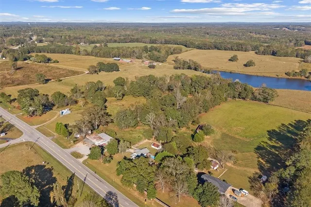 a view of a house with a yard and wooden fence