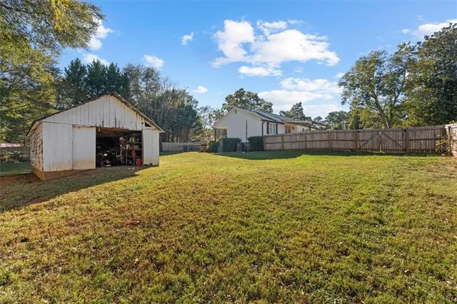 a view of a house with a yard patio and sitting area