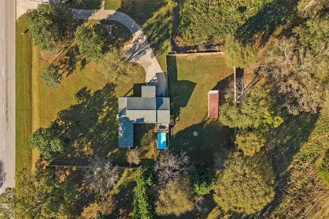a living room with furniture a flat screen tv and a window