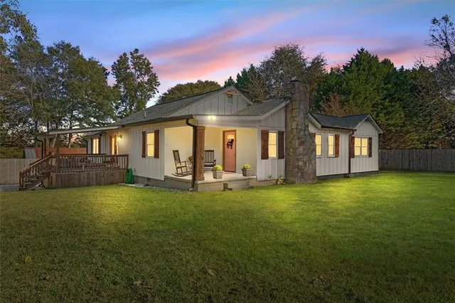 a front view of a house with swimming pool having outdoor seating