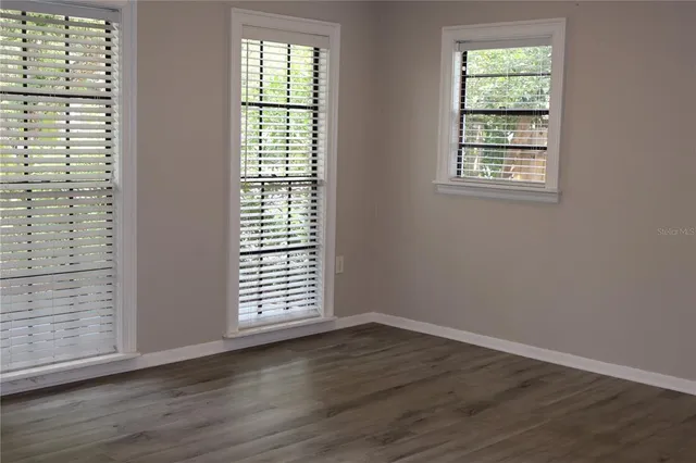 an empty room with wooden floor
