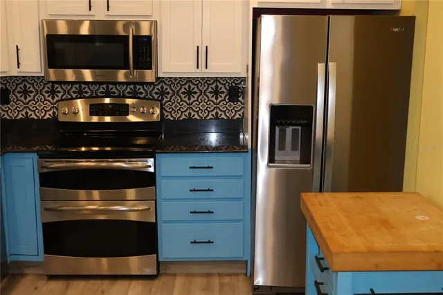 a kitchen with a stove and a microwave