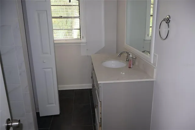 a bathroom with a toilet and a window